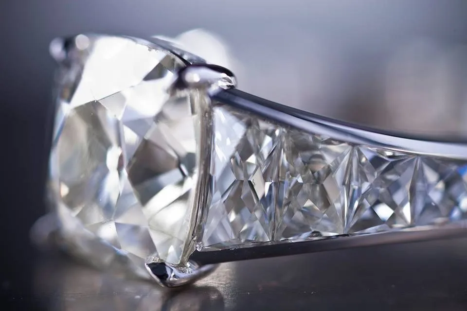 A cushion-cut diamond ring with matched French Cut side stones.