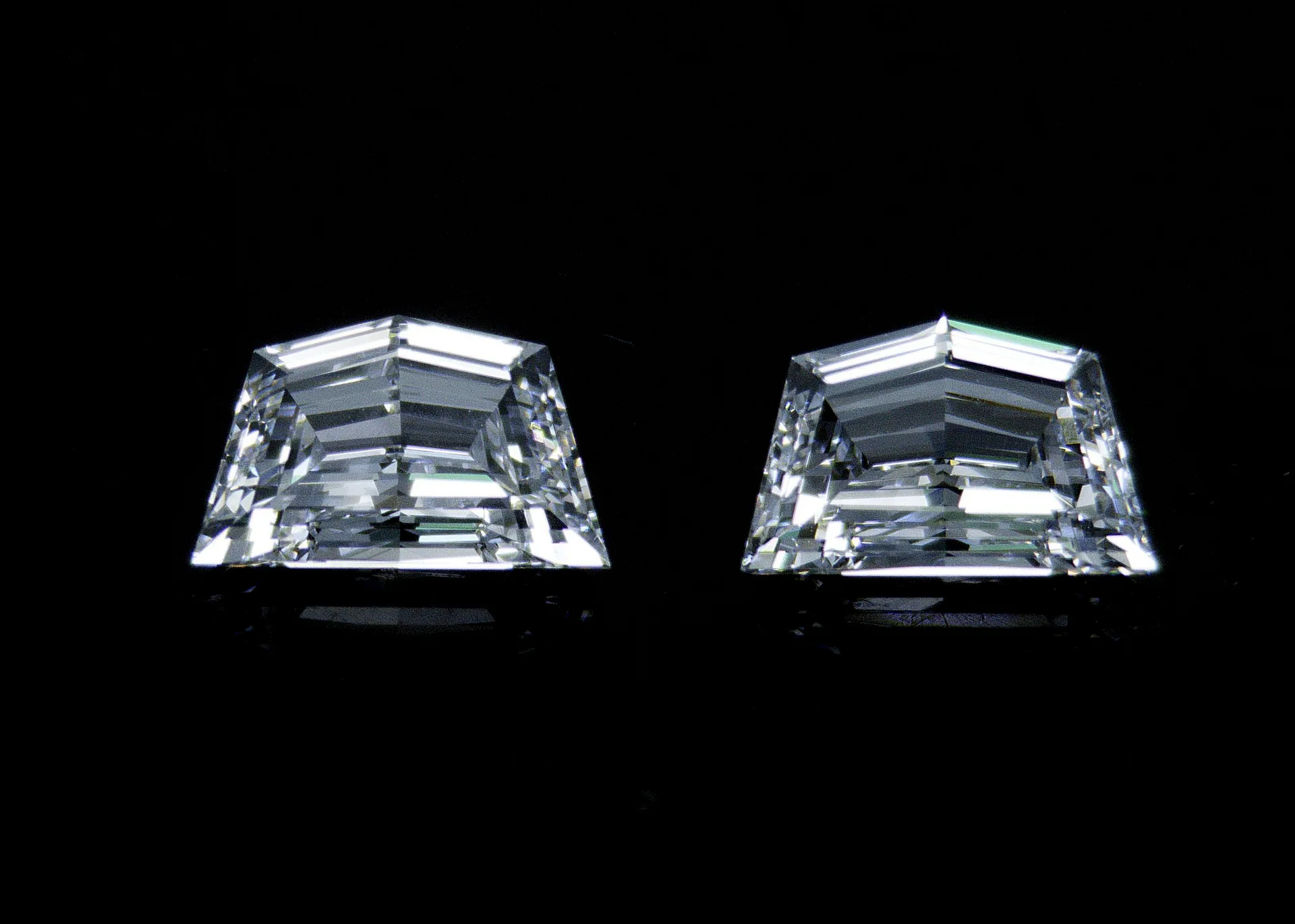 A matched pair of step-cut Cadillac diamonds, cut as twins.